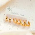 Three pairs of polished gold stainless steel hoop earrings in varying sizes on silk fabric - Hoop Style (BJGE0286) / Gold