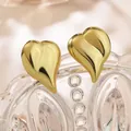 Polished gold heart stud earrings with irregular 3D textured design on a glass rim - Modern 3D Flowing Contour Heart Style (023)