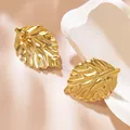 Minimalist matte gold leaf stud earrings with brushed texture on white stone base - Minimalist Matte Brushed Leaf Style (025)