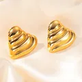Textured gold heart stud earrings with pleated surface on luxury silk background - Heart Shape with Lines