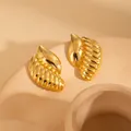 Elegant gold leaf-shaped stud earrings with textured ridges on a beige base - Irregular Studs Style (BJGE0836)