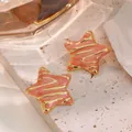 Macro detail of starfish earrings with pink marble enamel texture and gold accents - Star Style (FYD6188-red) / Red