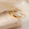 Detail of a vintage 18K gold-plated ginkgo leaf cuff bracelet with a matte brushed finish - Minimalist Smooth Open Style (#0260)