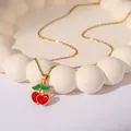 Gold stainless steel necklace featuring a red cherry enamel pendant on a white tray - Cherry