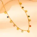 Detail of gold butterfly necklace with multicolor cubic zirconia charms on beige display - Butterfly Color Zirconia Style (N0160)