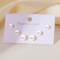 Close-up of three pairs of white pearl stud earrings on a purple stainless steel card - Artificial Pearl Studs Set (BJGE0907)