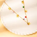 Golden butterfly necklace with colorful zircon stones on a white ceramic plate - Butterfly Color Beads Style (N0141)