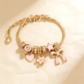 Golden snake chain bracelet featuring pink enamel heart, cherry blossom and butterfly charms - Pink Enamel Style (4405)