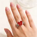 Silver gothic ring with red coffin stones and rose vine engravings on a hand - Gothic Rose Coffin Style (0343) / White K/Silver