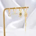 Elegant gold-tone earring set featuring heart zircon, tassels and letter pendants - Gold