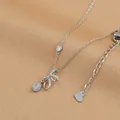 Macro detail of bow-knot necklace with opal teardrop and sparkling crystal accents - Bowknot Cat Eye Stone Style (XL62396) / Silver