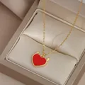 Detail of gold heart necklace with devil horns on luxury champagne satin jewelry box - Gold