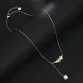 Detail of gold feather pendant with micro-set zircon and pearl drop on tassel chain - Feather Style (XL64106) / Gold