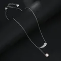 Detail of silver leaf pendant with cubic zirconia, pearl drop, and heart charm adjustment - Feather Style (XL64106) / Silver