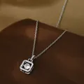 Close-up of gold-plated square pendant with sparkling cubic zirconia on a velvet base - Silver