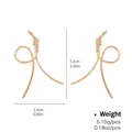 Elegant gold-tone hoop earrings with crisscross curved lines and sparkling cubic zirconia - Fashion Gold Crossover Curve Rhinestone Style (NCE03562)