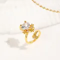 Macro detail of gold-plated nail ring with heart-shaped zircon and floral accent - Heart Zircon Floral Style (NCR01945) / Gold