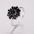Macro detail of silver adjustable ring with sunflower design and black crystals - Silver