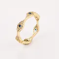 Detailed view of wave-shaped gold ring with blue devil eye motifs and zircon inlays - Evil Eye Wave Style (NCR01389) / Gold