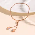 Elegant rose gold adjustable heart bracelet with zircon stones on white ceramic plate - Rose Gold Double Heart Box Chain Style (NCB00058-1)