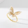 Detail of gold butterfly ring featuring inlaid white pearls and sparkling zircons - Gold