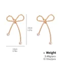 Classic gold twisted bow-shaped hoop earrings with sparkling cubic zirconia accents - Twisted Wire Bow Rhinestone Style (NCE01952)