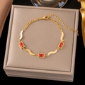 Elegant gold titanium steel bracelet featuring rectangular red zircon accents and wavy links - 【sle2021】three Red Square Diamond Bracelet Gold