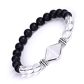 Close-up of matte black onyx beads with a clear quartz pyramid charm and silver accents - White Crystal Pyramid Matte Stone Bracelet