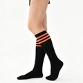 Knee-high black athletic socks featuring three orange stripes in a sporty varsity style - One Size
