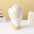 Close-up of gold tulip oval pendant on rope chain displayed on a wooden jewelry bust - White Leather Large