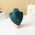 Detailed view of silver heart pendant with blue gems on a green velvet necklace stand - Dark Green Velvet Small