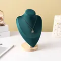 Detail of dark green velvet necklace bust stand with solid wood base and snowflake pendant - Dark Green Velvet Medium