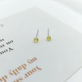 Detailed macro view of S925 silver stud earrings with vibrant yellow zircon stones - Bright Yellow