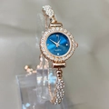 Detail shot of a rose gold quartz watch with blue sunray dial and crystal bracelet - Blue