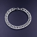Polished silver stainless steel Cuban link bracelet with lobster clasp on black background - Steel