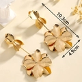 Detalle de pendientes florales dorados con dimensiones 10,3 cm y 4,9 cm en fondo beige - Pendientes De Borla Chapados En Oro (hierro)