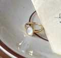 Golden open ring featuring an oval mother-of-pearl stone on a ceramic tray - Oval Mother Of Pearl Texture Open Ring (JZ0572)