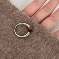 Adjustable silver ring with brown tiger eye stone on a warm knitted background - Artificial Tiger Eye Bead Open Ring