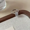 Elegant silver flower ring featuring an oval-cut diamond and pavé settings on the band - Silver Waterdrop Pave Rhinestone Open Ring
