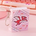 Pink book-shaped mini electronic pet game keychain with red cartoon dragon design - Book Shape Flip/Pink