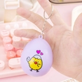 Purple egg-shaped digital pet keychain featuring a yellow chick pattern and metal ring - Egg Shell Flip/Purple