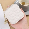 Mini ivory quilted lipstick case with star charm and gold zipper on a chic pouch - White