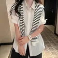 Classic black and white striped knit shawl accessory styled over a white short sleeve shirt - White Base Stripe (Large)