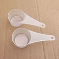 Set of two translucent plastic measuring spoons with hanging holes for kitchen use - Clear
