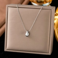 Polished silver teardrop pendant necklace in titanium steel on jewelry display case - XLH492 Water Drop / Steel