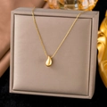 Elegant gold titanium necklace featuring a polished water drop pendant on a silk background - XLH449 Water Drop / Gold