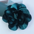 Macro detail of 14cm emerald green satin fabric flower with layered petals and silk texture - Malachite green