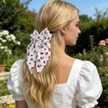 Sweet white bow hair clip with cherry print and long ribbons for elegant summer hairstyling - White Background Red Cherry Print / White