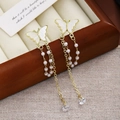Detail of butterfly tassel earrings with gold finish, pink beads and crystal pendants - Gold Butterfly Pearl Tassel
