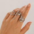 Detailed view of silver liquid metal rings with irregular lava design on hand - White K/Silver